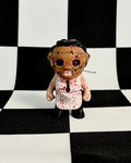 Small doll with a checkered black and white background
