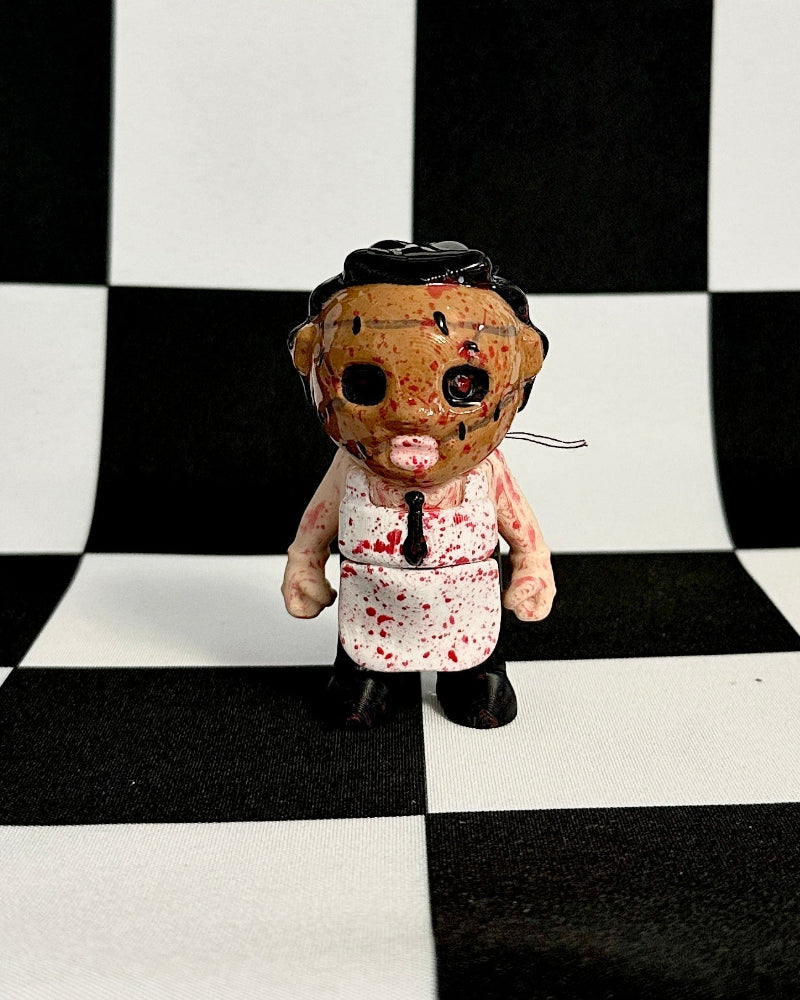 Small doll with a checkered black and white background
