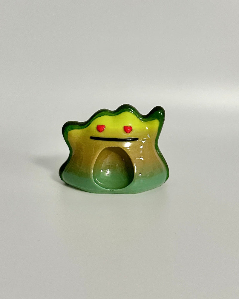 Small green avocado shape with a face on a white background