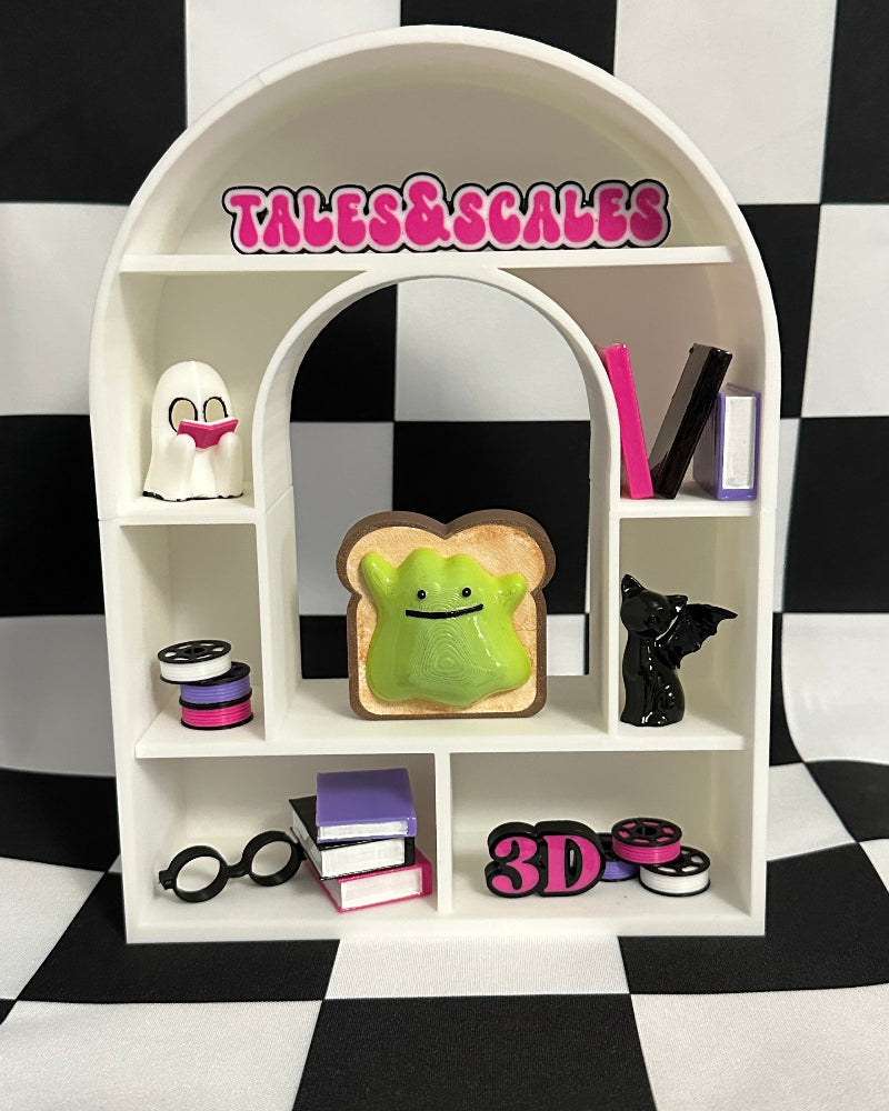 White arch-shaped shelf with various items on a black and white checkered background