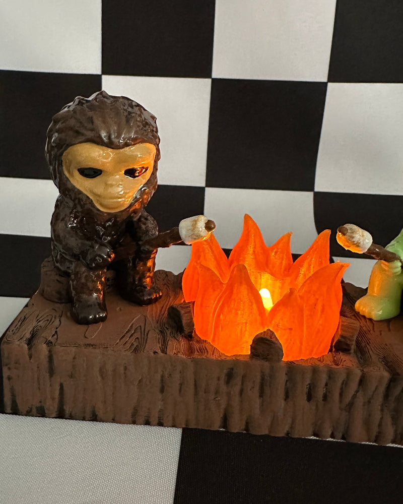 Small figurine roasting marshmallows over a campfire against a checkered background