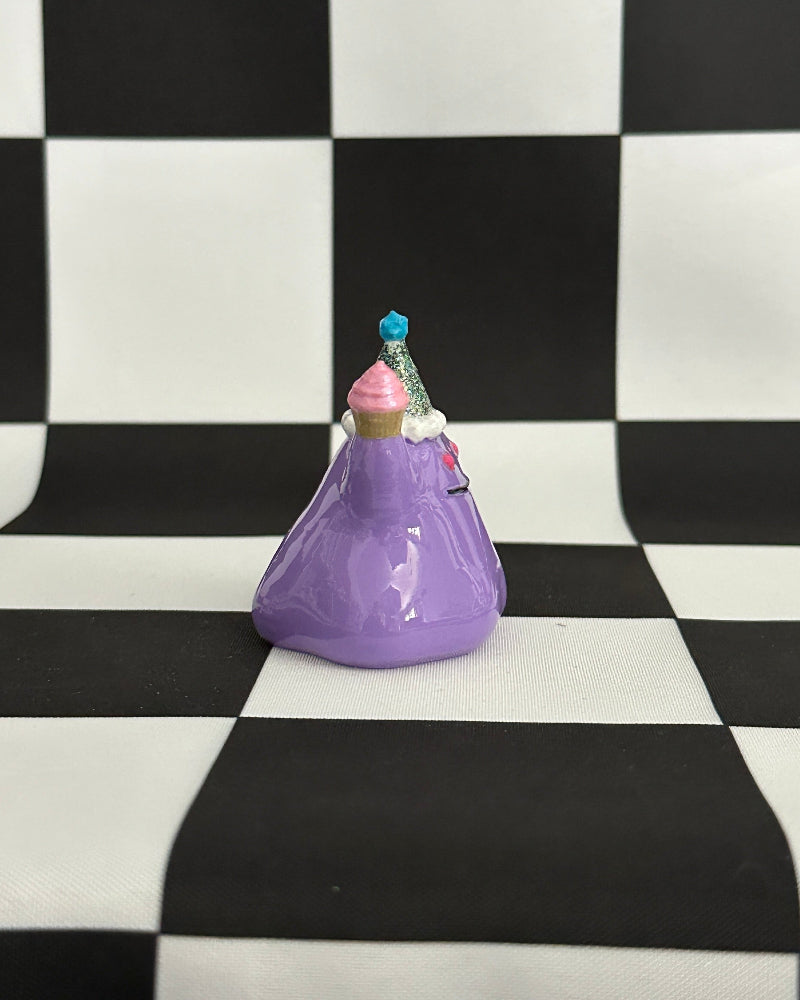 Purple decorative item on a checkered black and white background