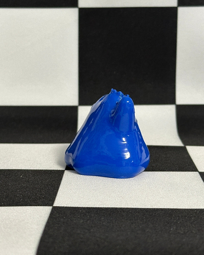 Blue object on a black and white checkered background