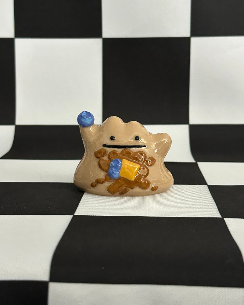 Small figurine with a checkered background
