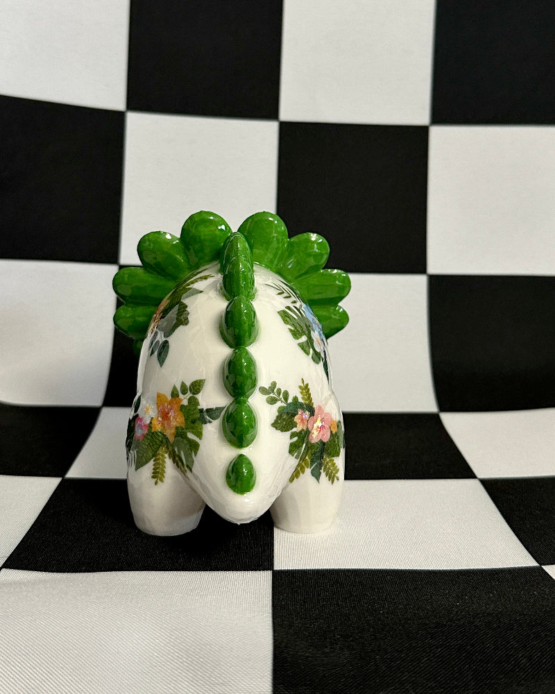 Decorative object with green leaves on a checkered background