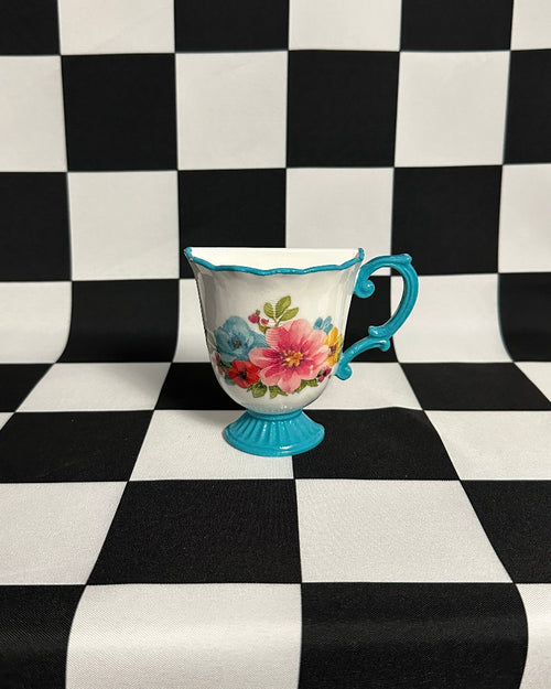 Silver vase on a black and white checkered background