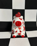 Decorative item with red hearts on a black and white checkered background