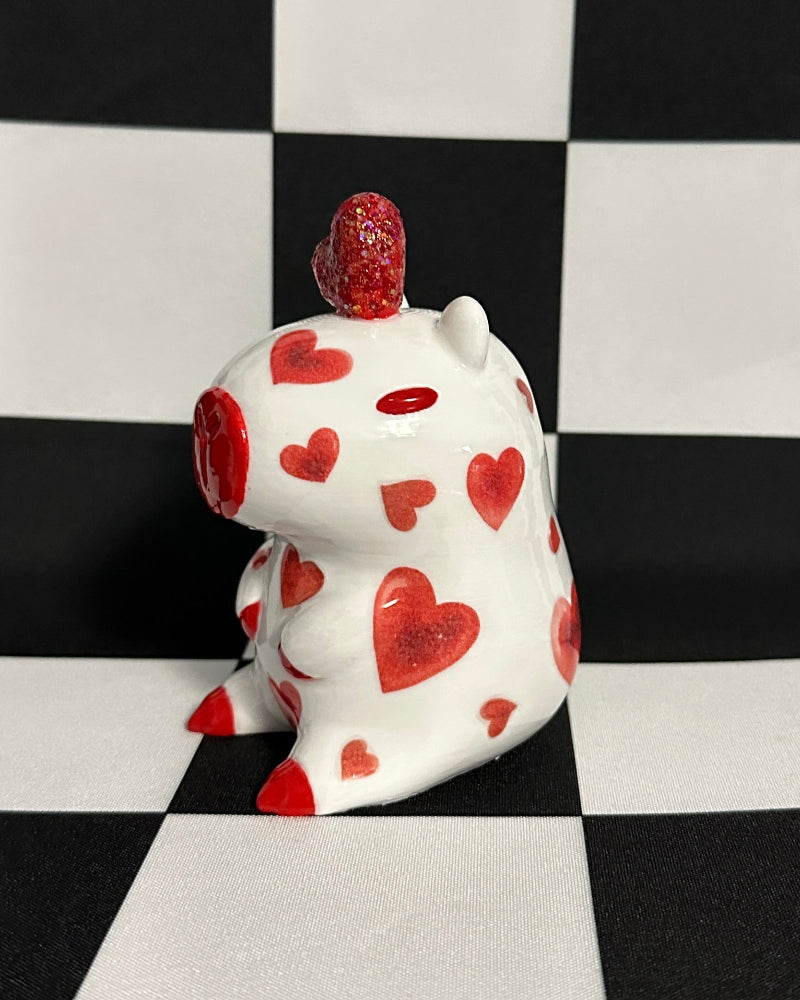 capybara with red hearts on a black and white checkered background
