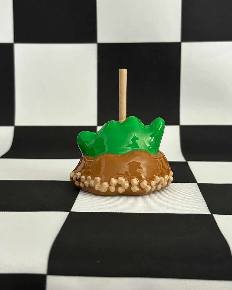 Toy turtle on a stick with a checkered background