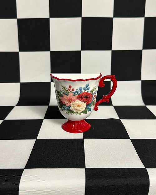 Decorative teacup with floral design on a black and white checkered background