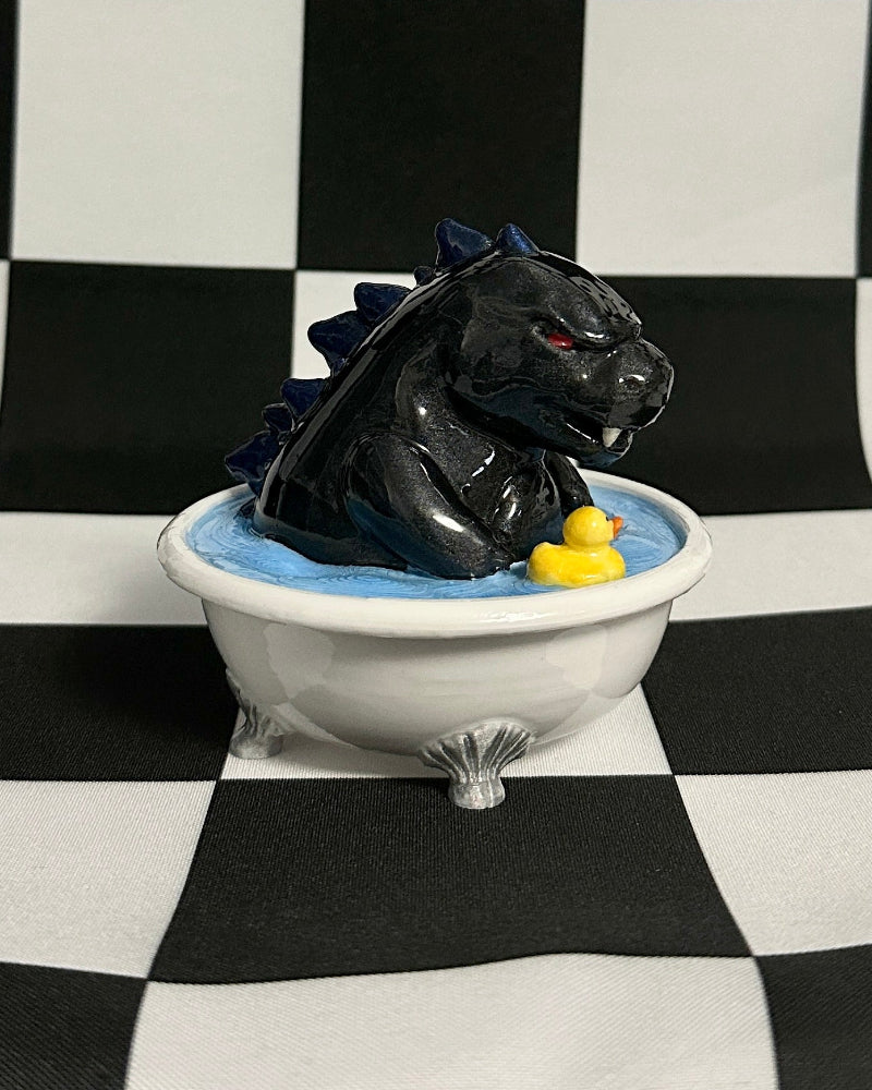 Black panther figurine in a bathtub with a checkered background