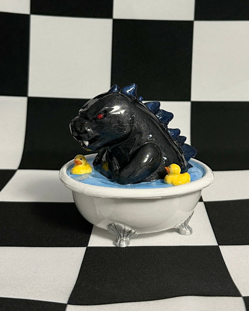 Black creature in a bathtub with yellow balls on a black and white checkered background