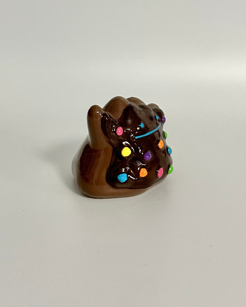 Small brown bear figurine with colorful lights on a white background