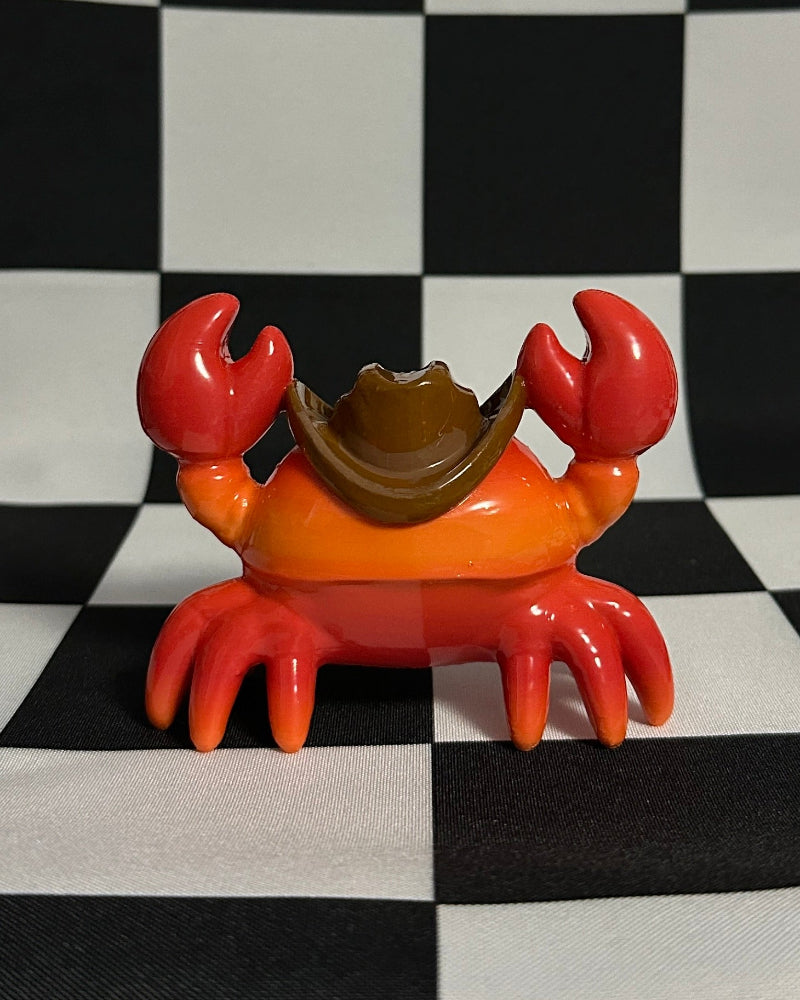 Crab-shaped object on a black and white checkered background