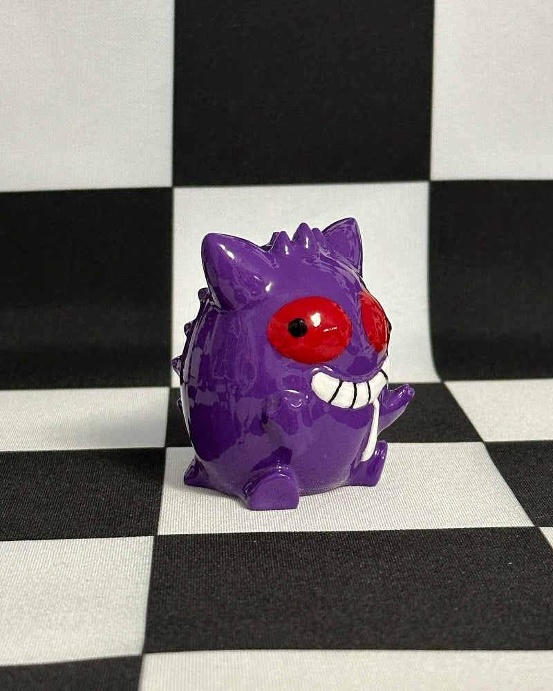 Purple cartoon character with red eyes on a black and white checkered background