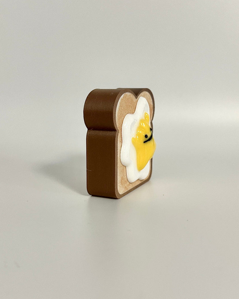 Small wooden clock with a yellow face on a white surface