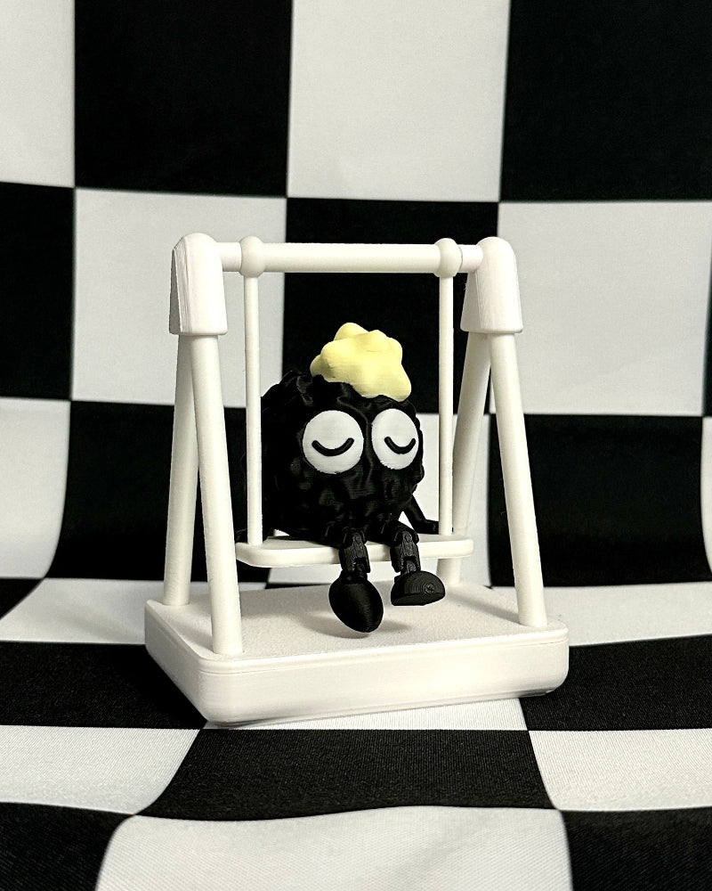 Small figure on a swing against a black and white checkered background