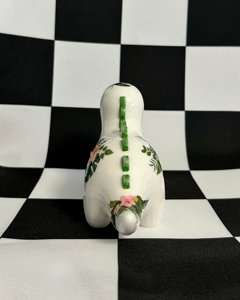 Decorative gourd with floral patterns on a black and white checkered background