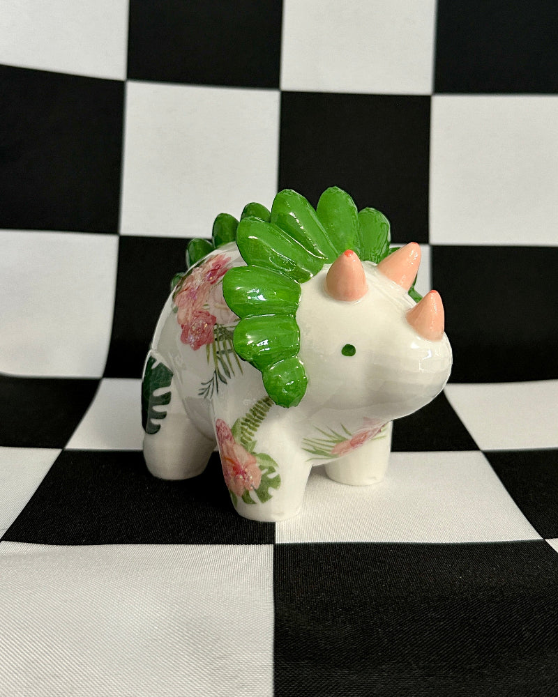 Decorative ceramic animal figurine with floral patterns on a black and white checkered background