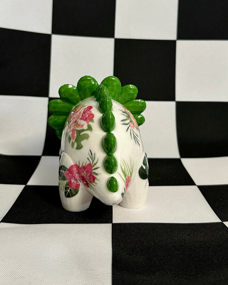 Decorative ceramic piece with floral design on a checkered background