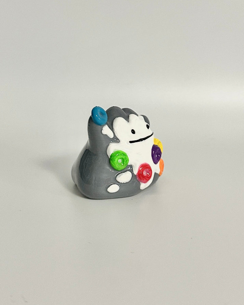 Small decorative figurine on a white surface with a neutral background