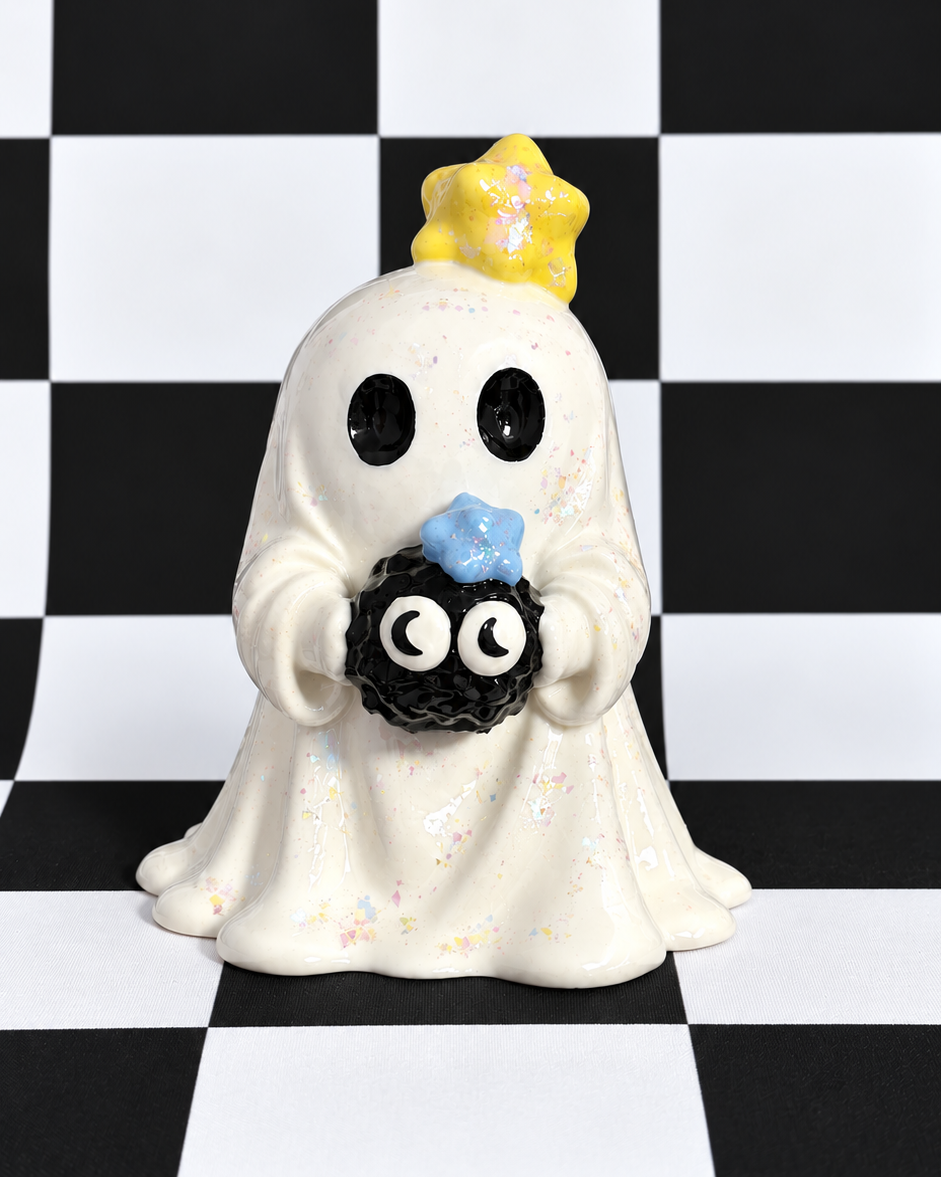 A cute ghost figurine holding a small black spider, set against a black and white checkered background.