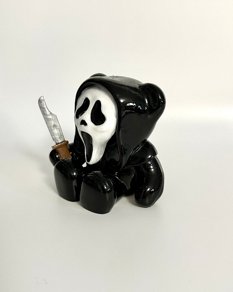 Black bear figurine with a smoking pose on a white background