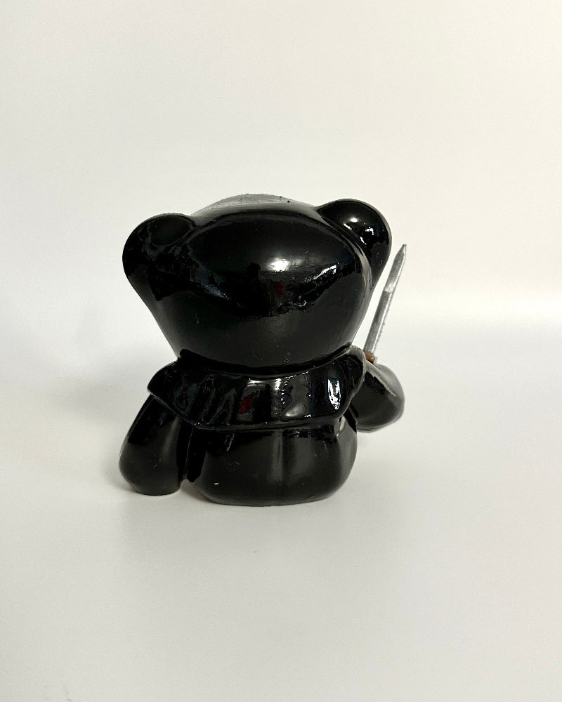 Black bear-shaped object with a white background
