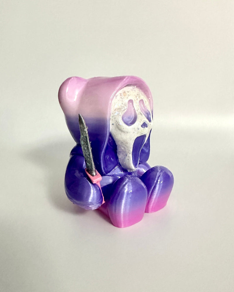 Gradient purple and pink figurine with a face on a white background