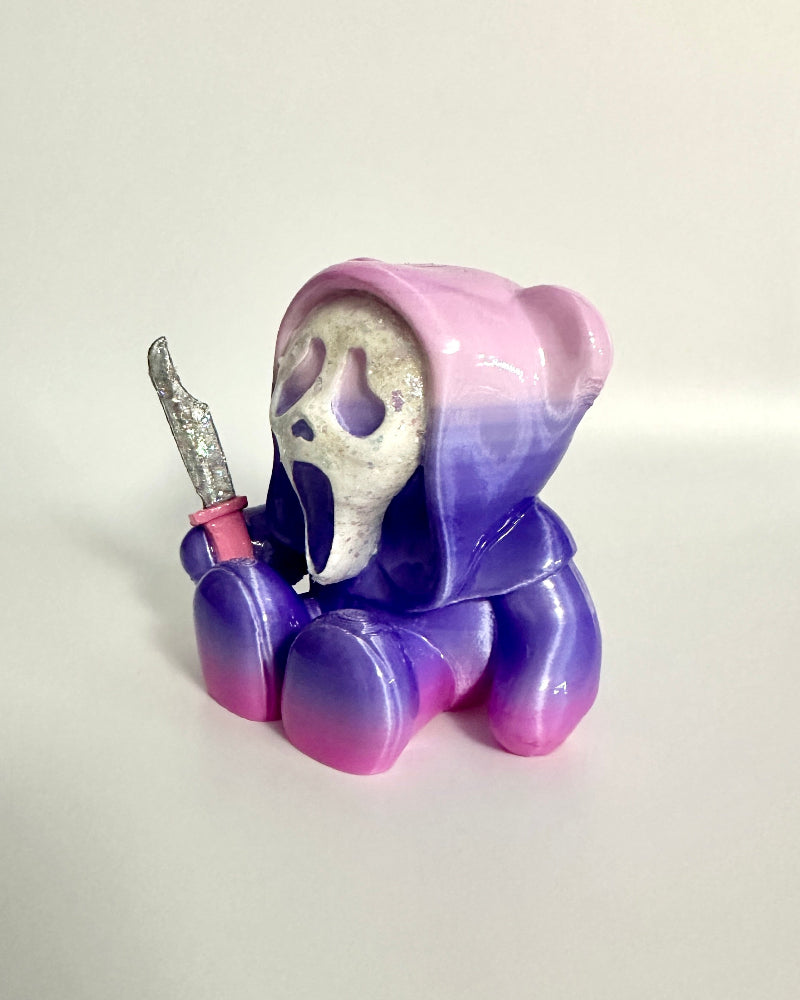 Colorful character figurine with a pink object on a white background
