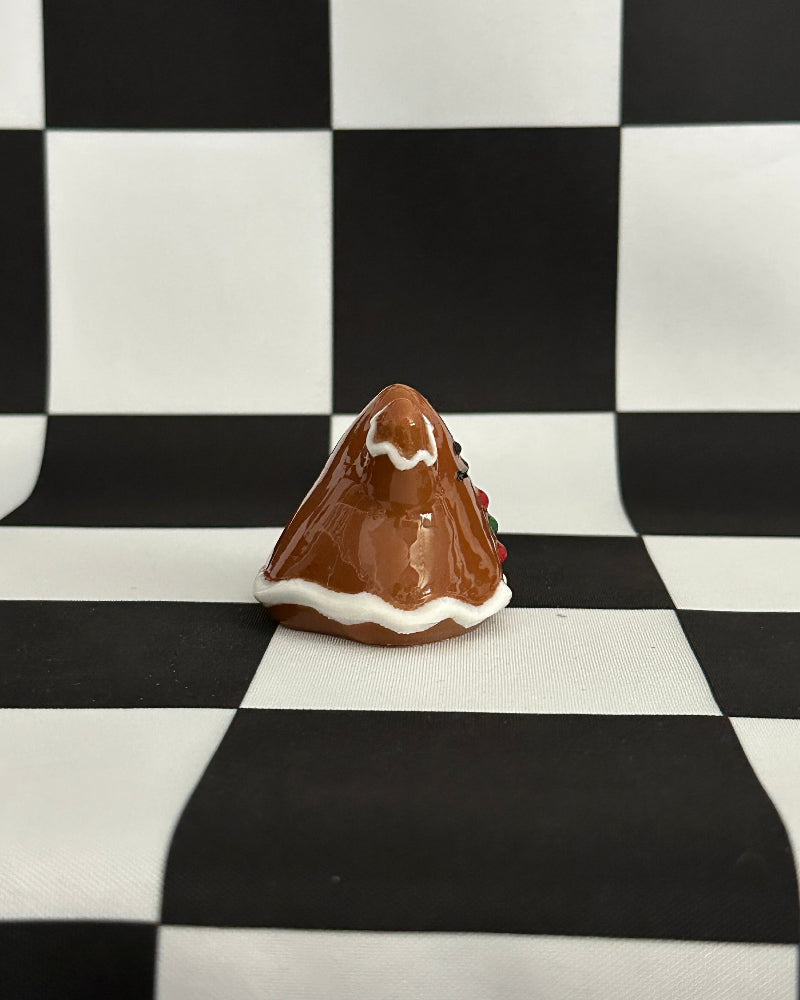 Small chocolate mountain figurine on a black and white checkered background