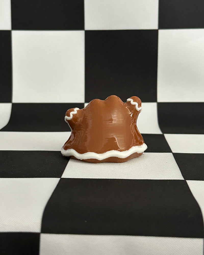 Small brown and white object on a black and white checkered background