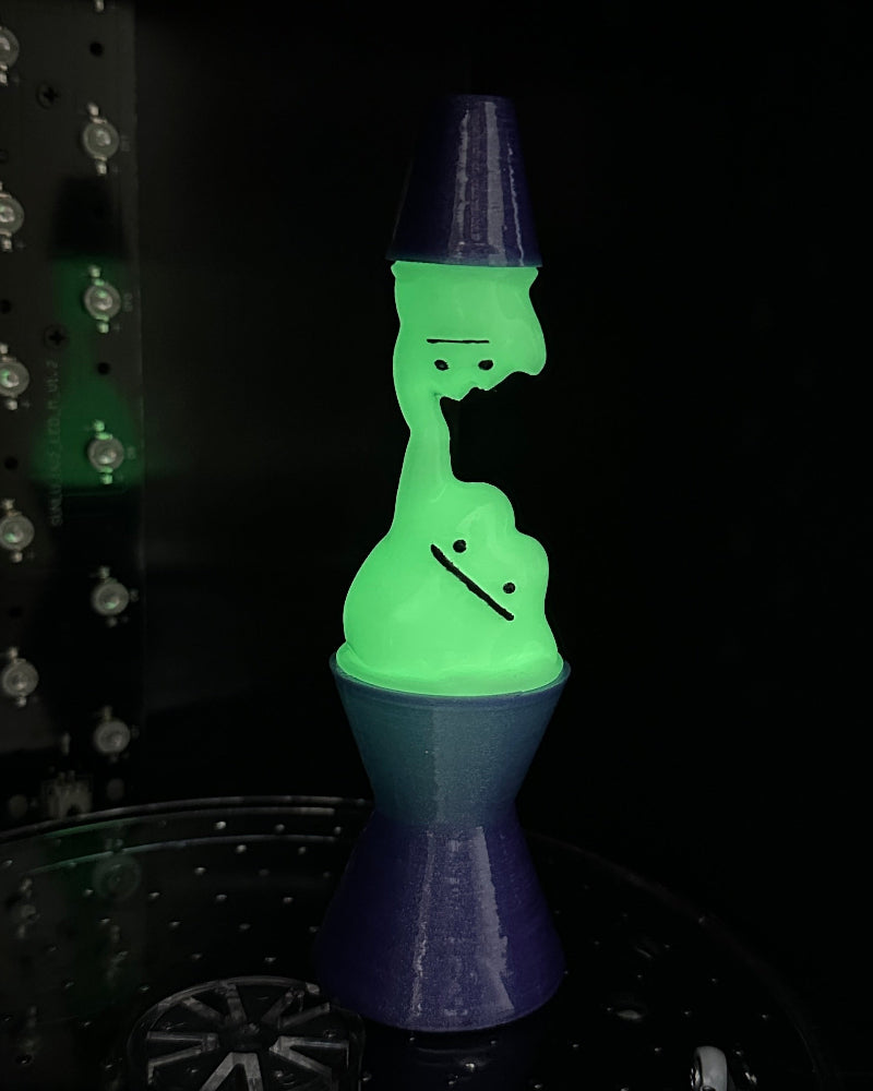 Glowing green and purple lamp on a dark background