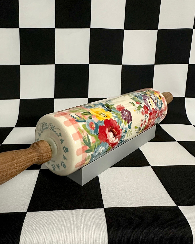 Decorative rolling pin with floral design on a black and white checkered background