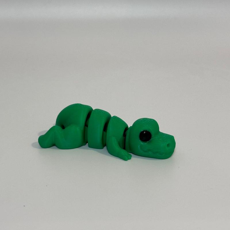 SnuggleSaurus: Green Mini Laying Down Baby T-Rex Fidget Collectible