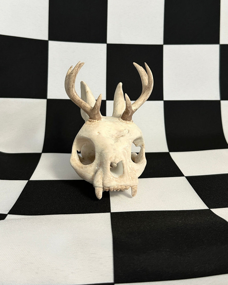 jackalope skull on a black and white checkered background