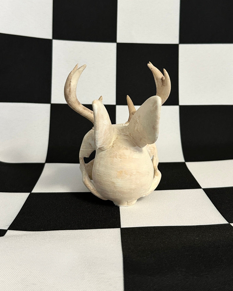 jackalope skull on a checkered black and white background