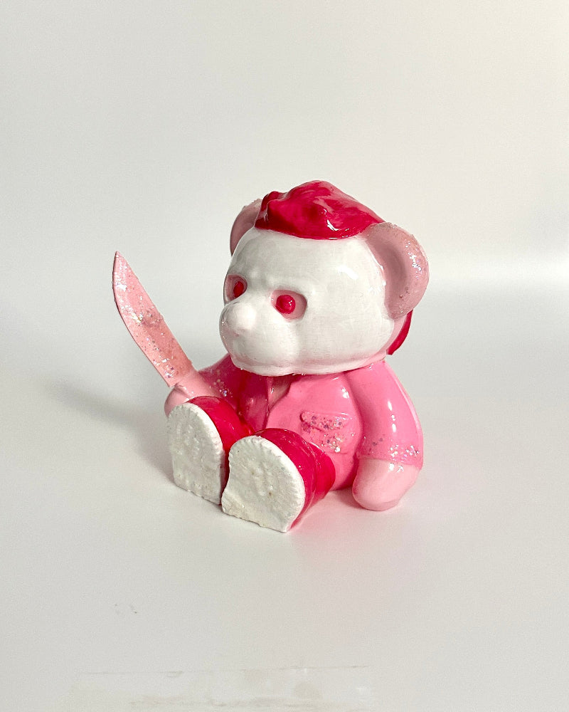 Pink and white cartoon character figurine on a white surface
