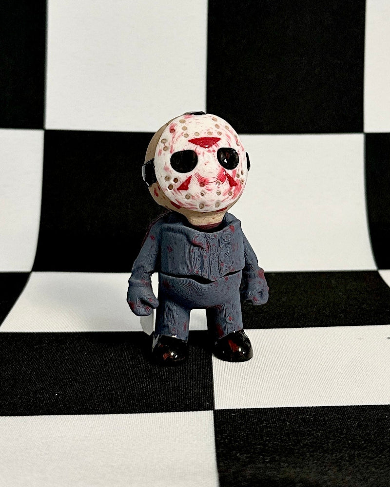 Figurine with a mask on a black and white checkered background