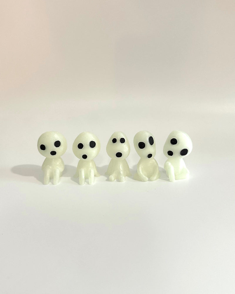 Five small ghost figurines on a white background