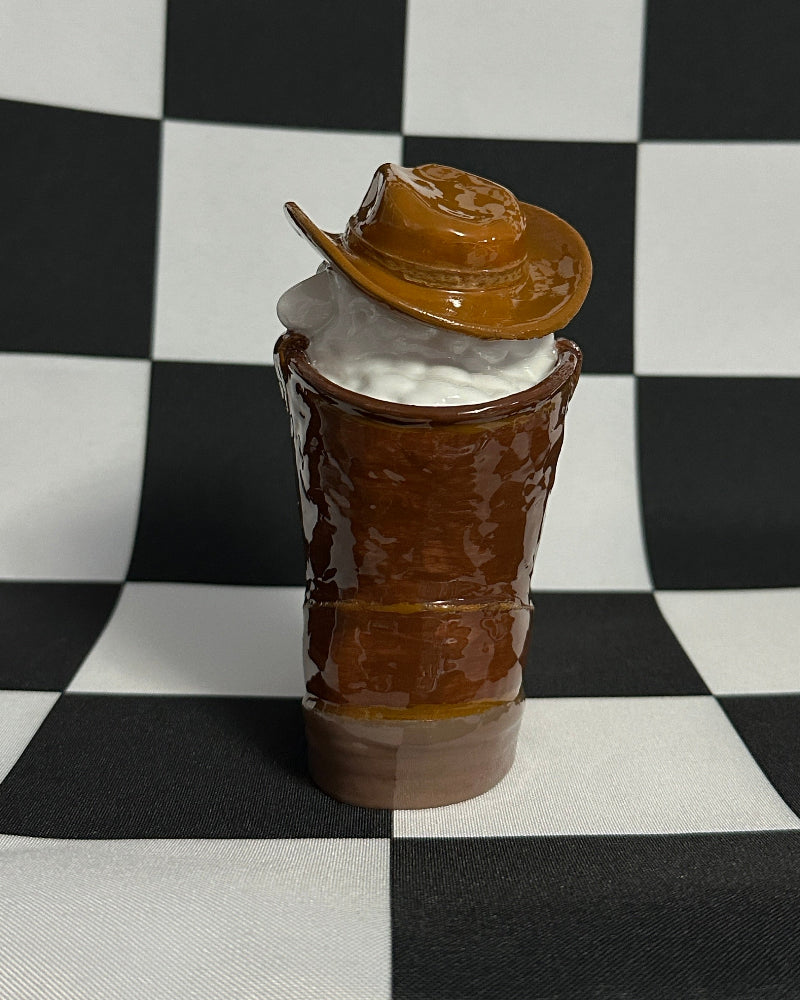Model of a boot with a helmet on a checkered black and white background