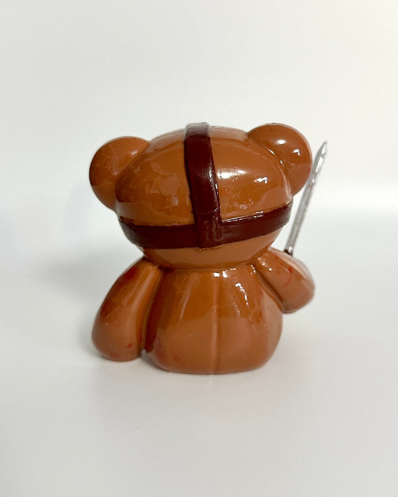 Brown teddy bear-shaped object on a white background