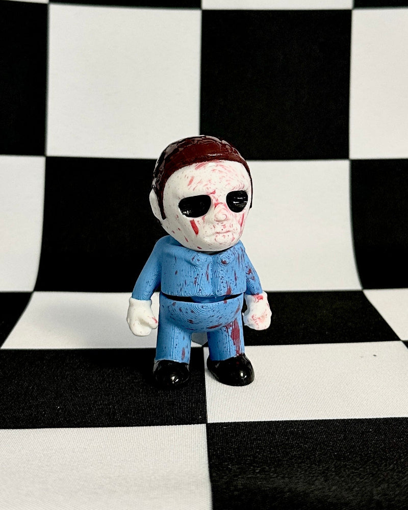 Toy figure of a character in a blue outfit on a black and white checkered background