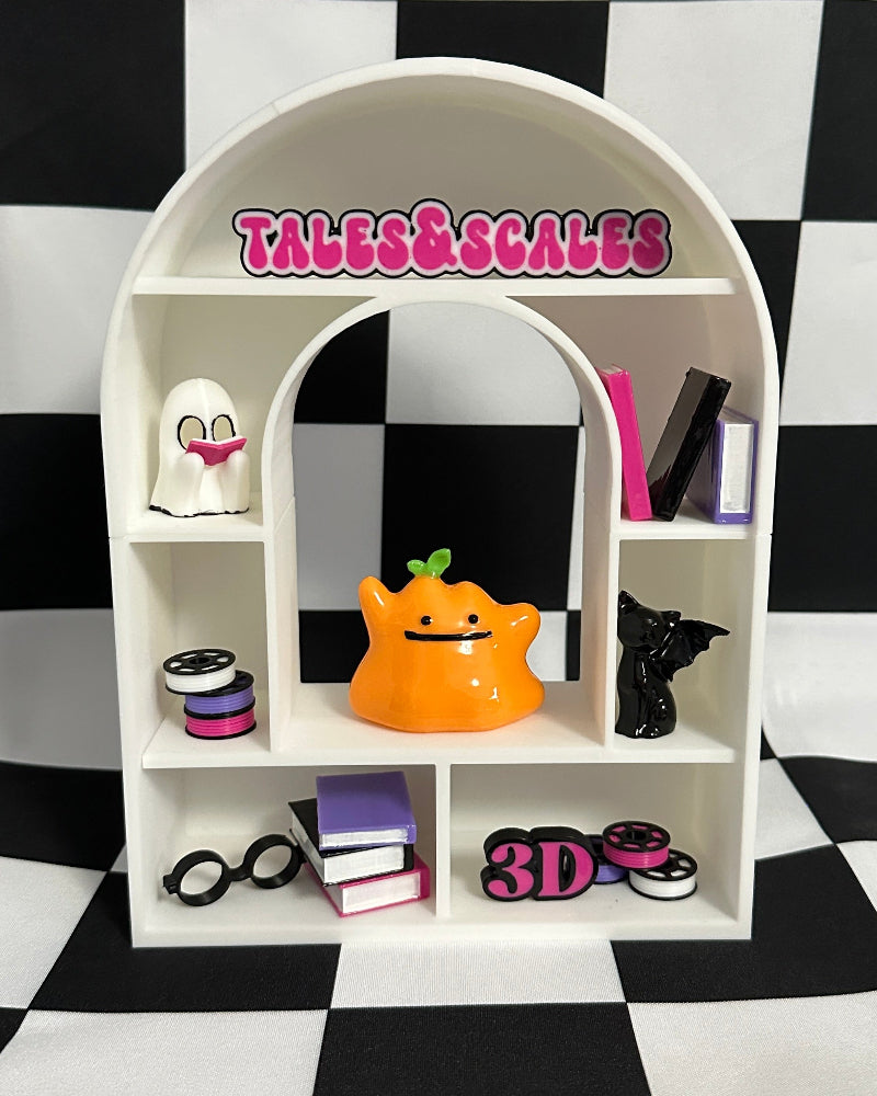 Small white arch-shaped shelf with various items against a black and white checkered background