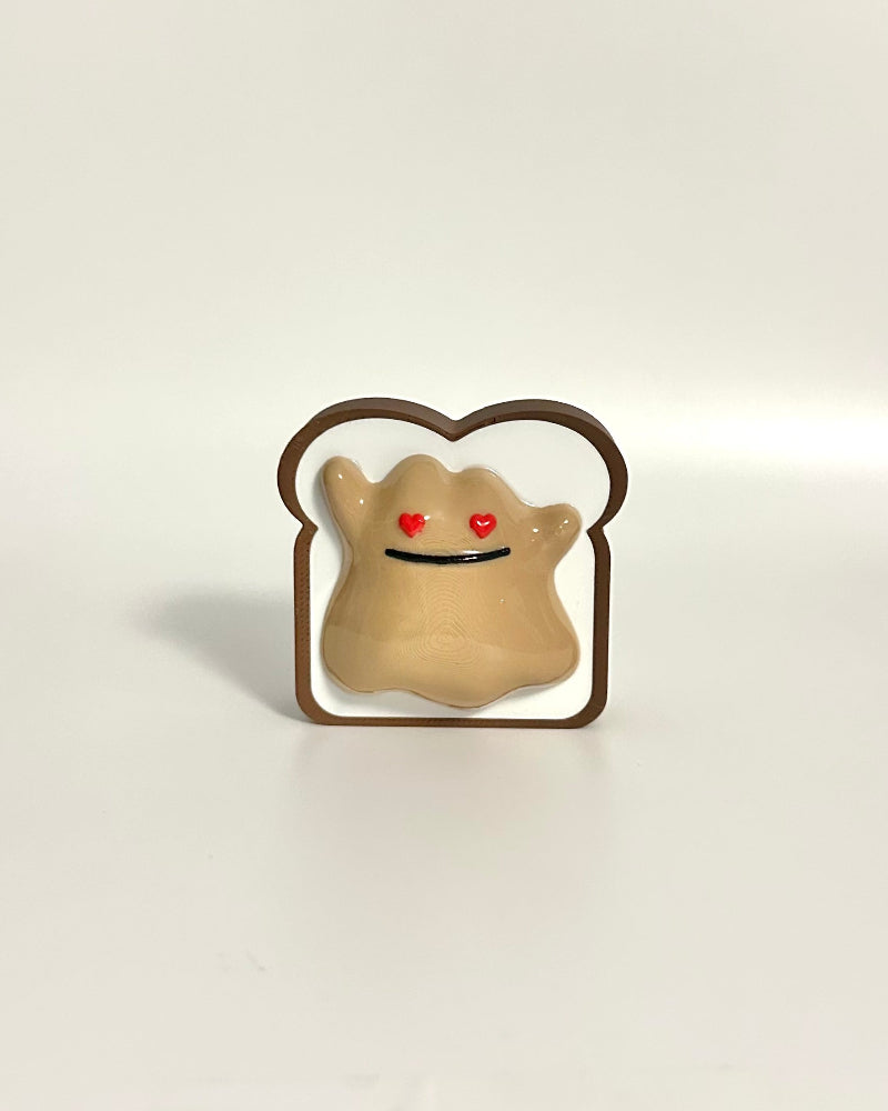 Toy figure of a character in a slice of bread on a white surface