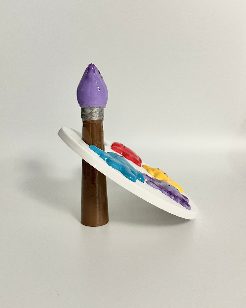 Colorful makeup palette with a purple brush on a white background