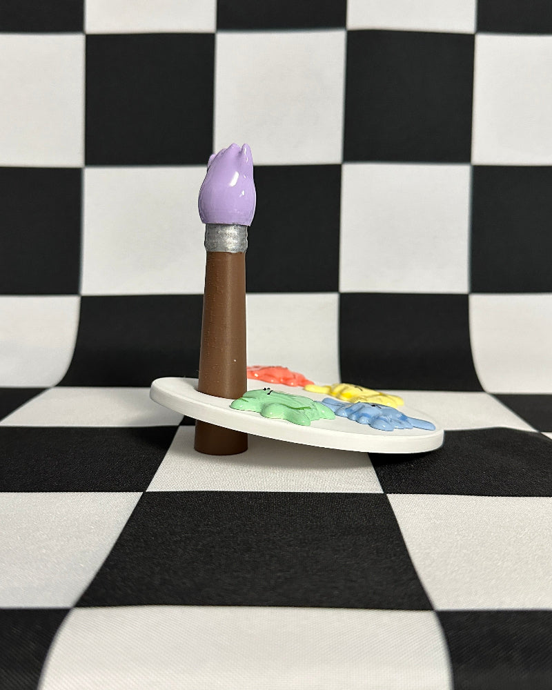 Paintbrush with a purple handle on a palette against a checkered background
