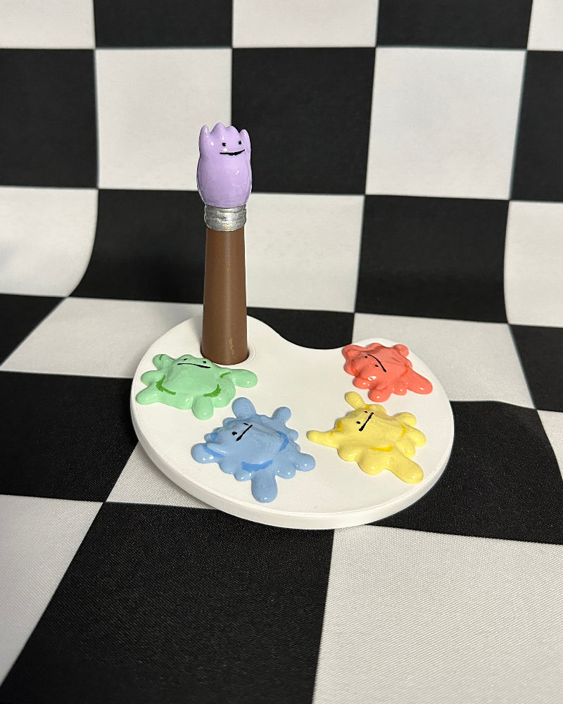 Colorful children's paintbrush holder with numbers on a checkered background