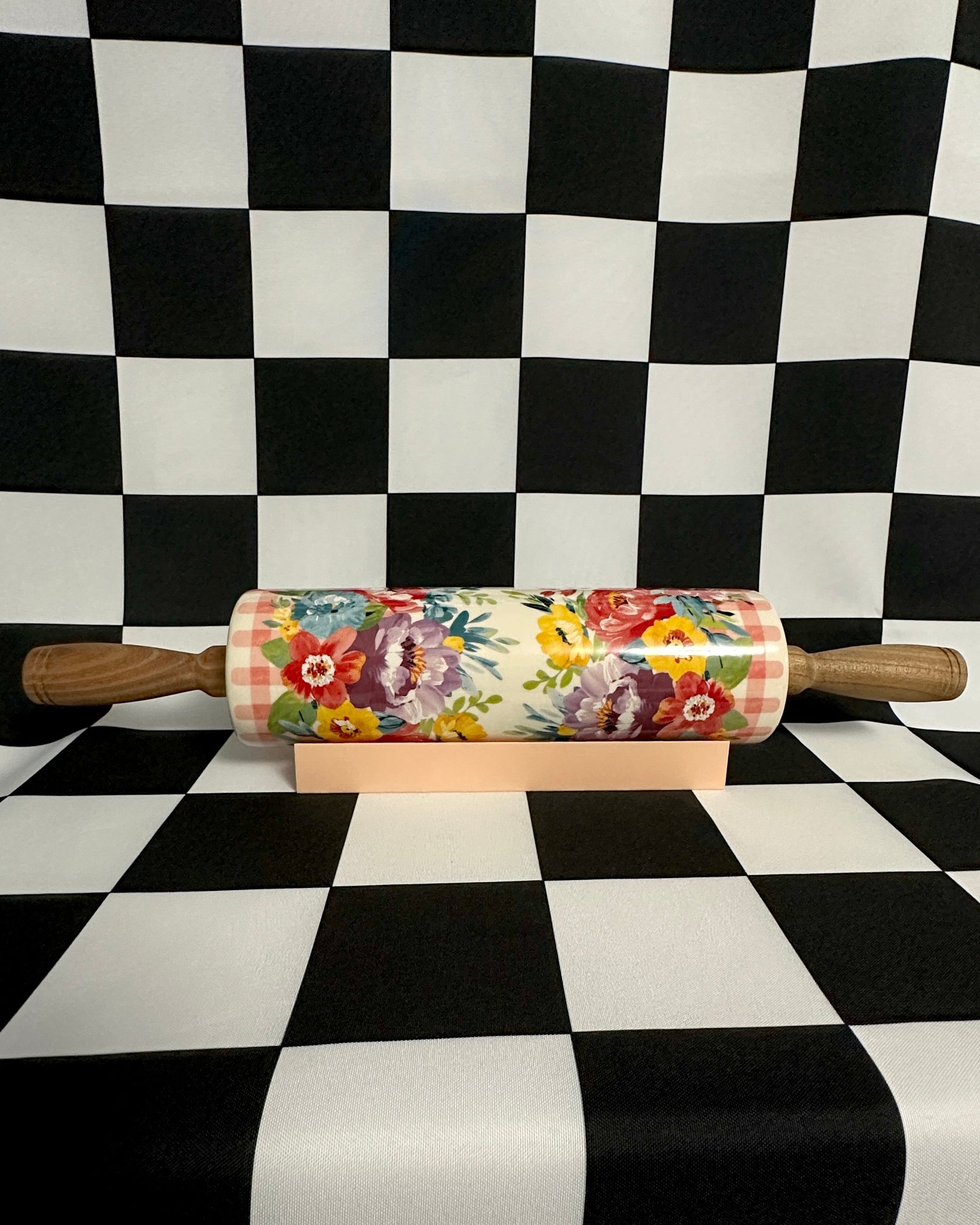Decorative rolling pin with floral design on a checkered background
