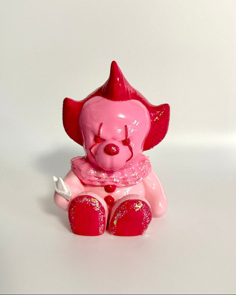 Pink piggy bank with red hair on a white background